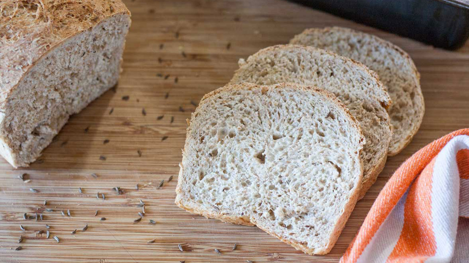 3 slices rye bread on bamboo cutting board