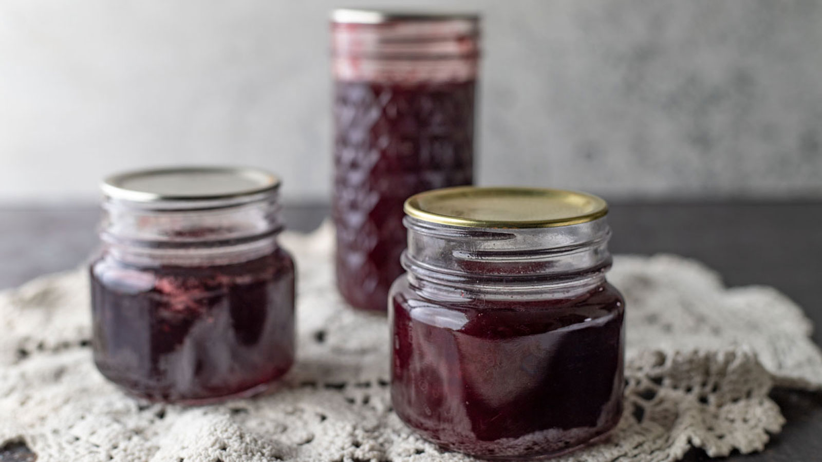 Three jars of jam close up photo.