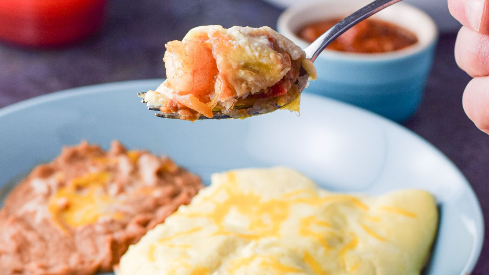 A plate of shrimp enchiladas with spoon