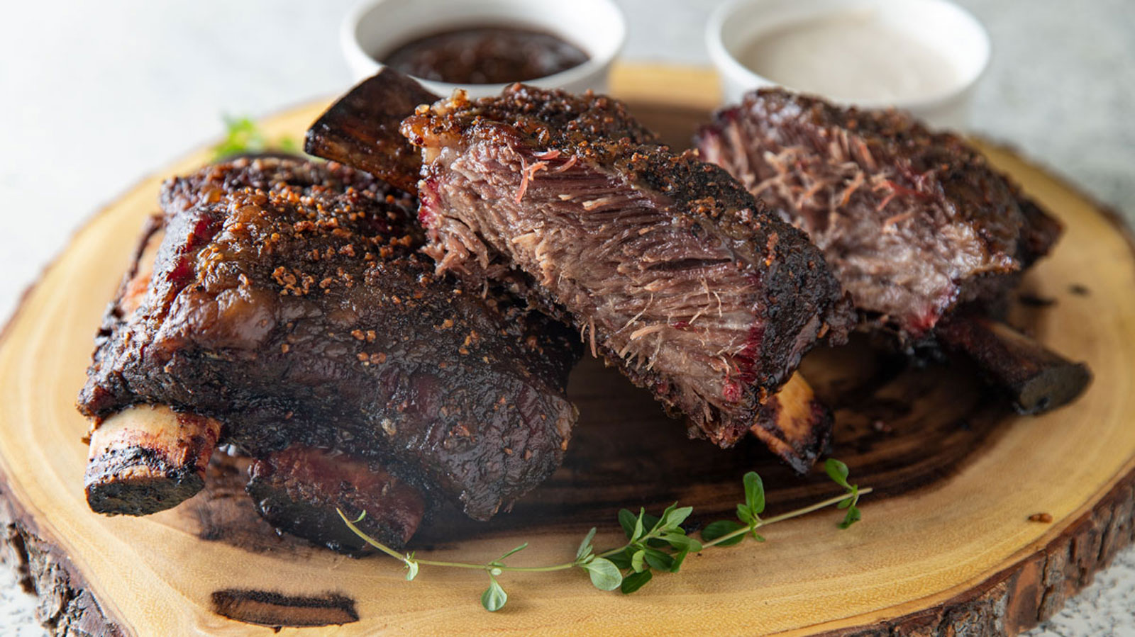 Beef ribs on a wooden board.