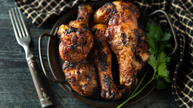 Smoked chicken legs in a pewter tray.