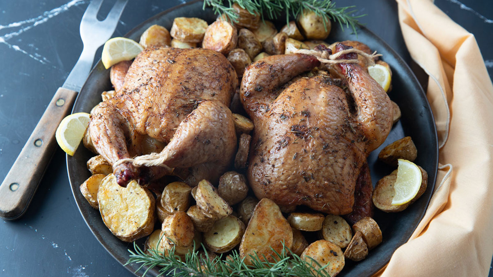 Cornish game hen with roasted potatoes.