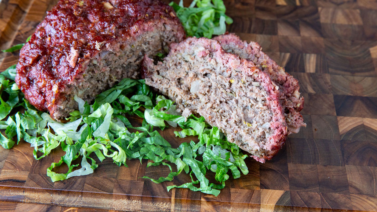 Slices of meatloaf on a cutting board.
