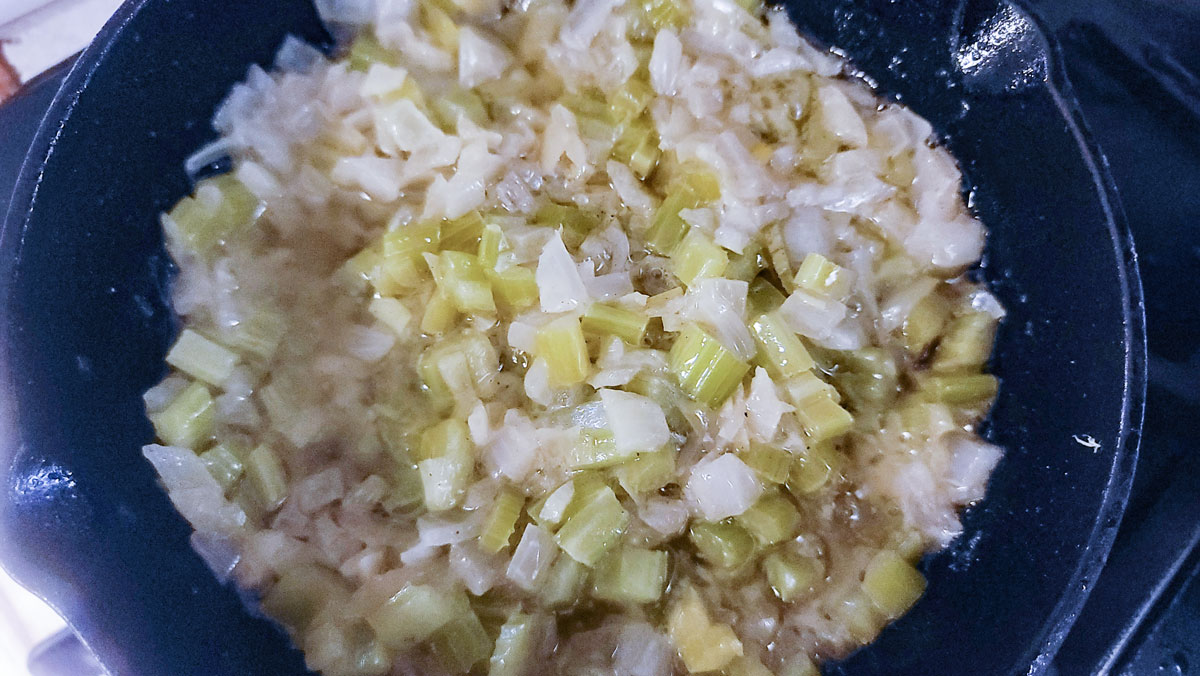 Onion and celery cooked down in skillet.