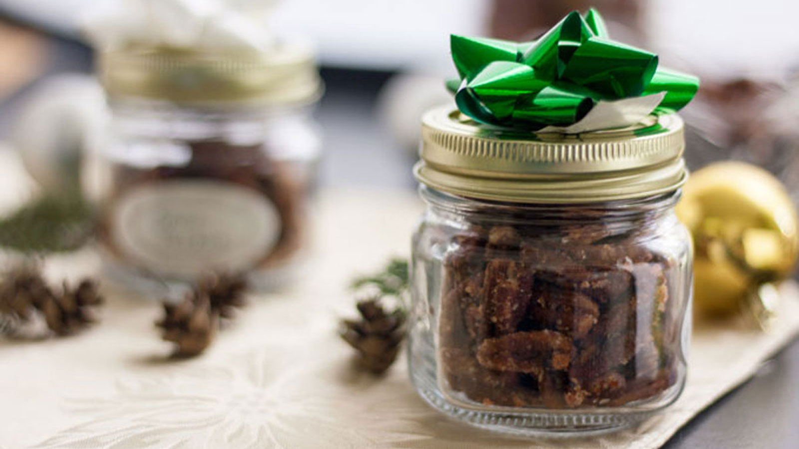 Spicy nuts in jars with a bow on top.