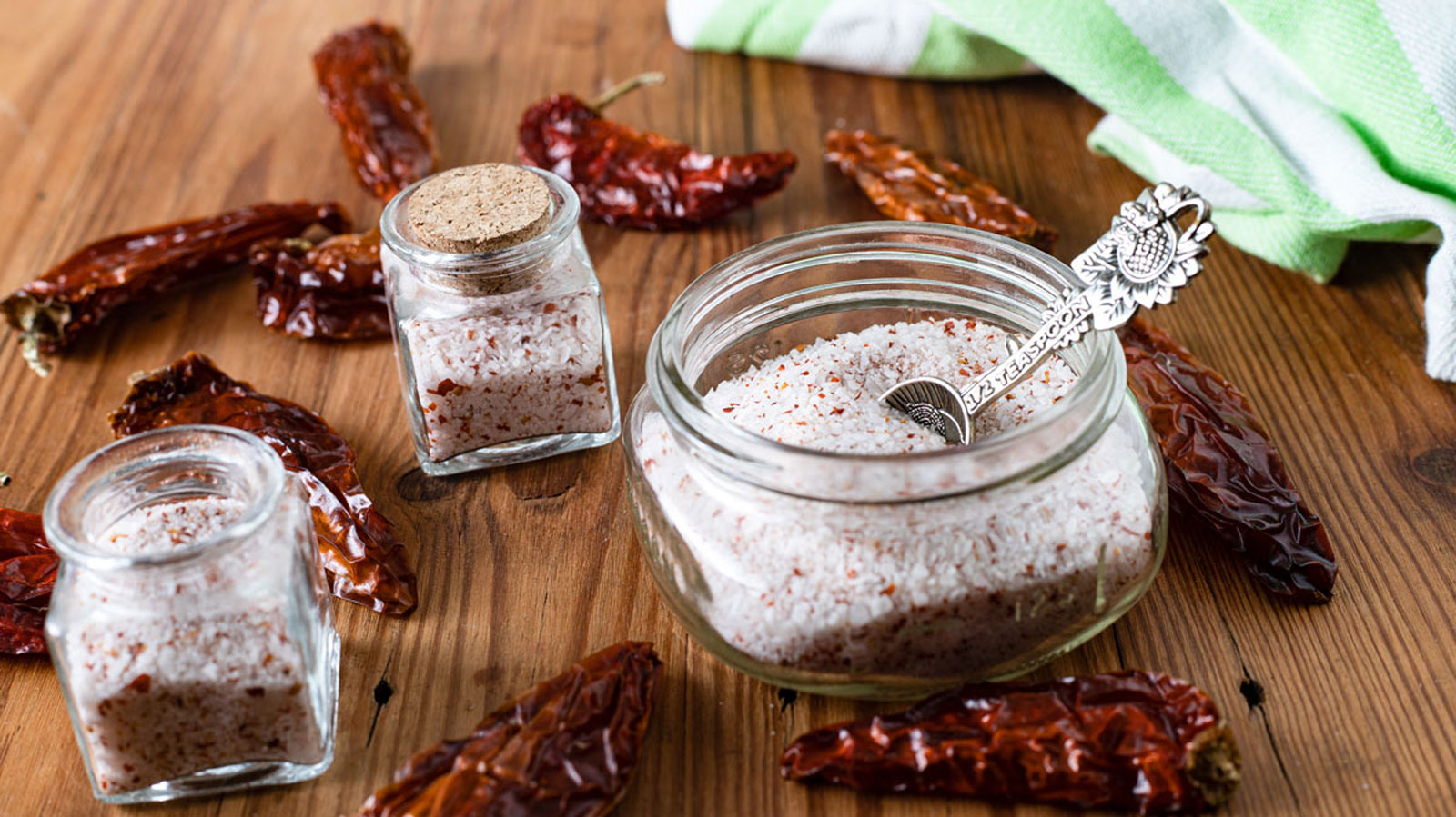 Jars with a spicy salt with a decorative spoon.