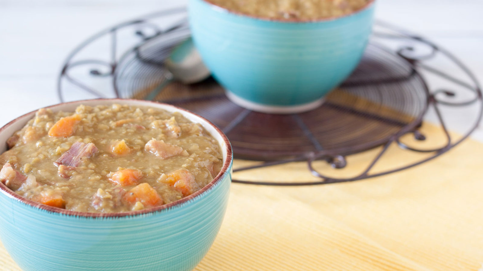 Split pea soup in aqua bowls.