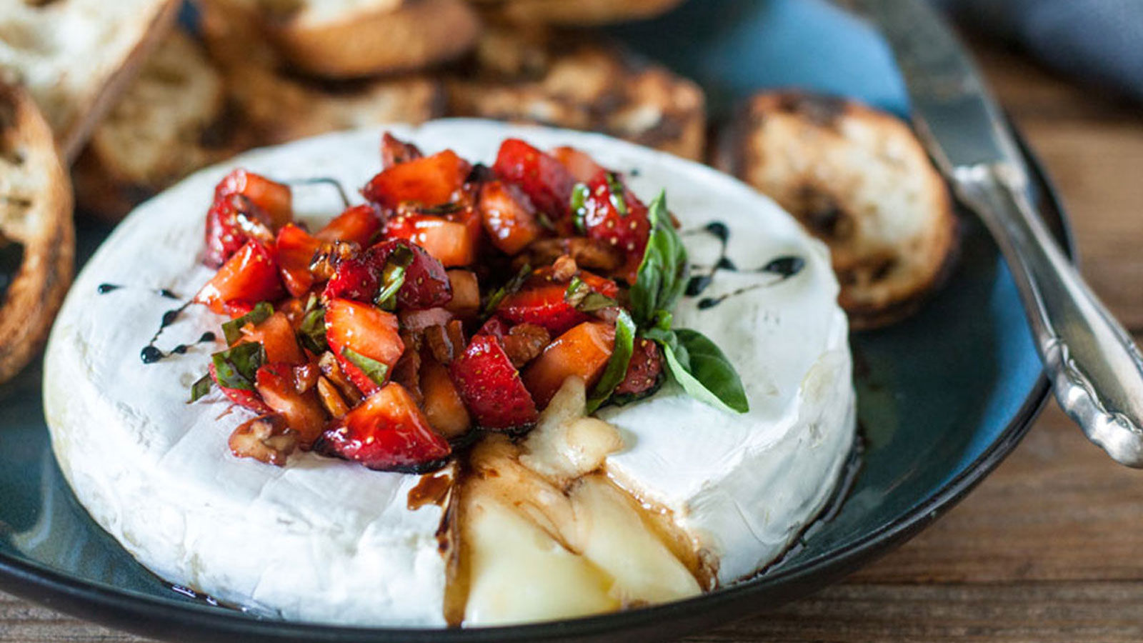 Brie cheese with strawberries on top.