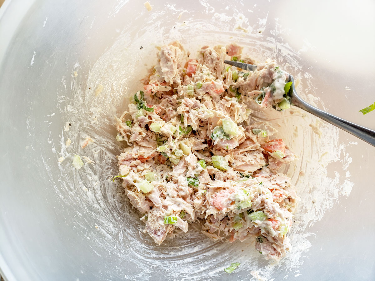 Tuna fish with carrots and celery in a bowl.