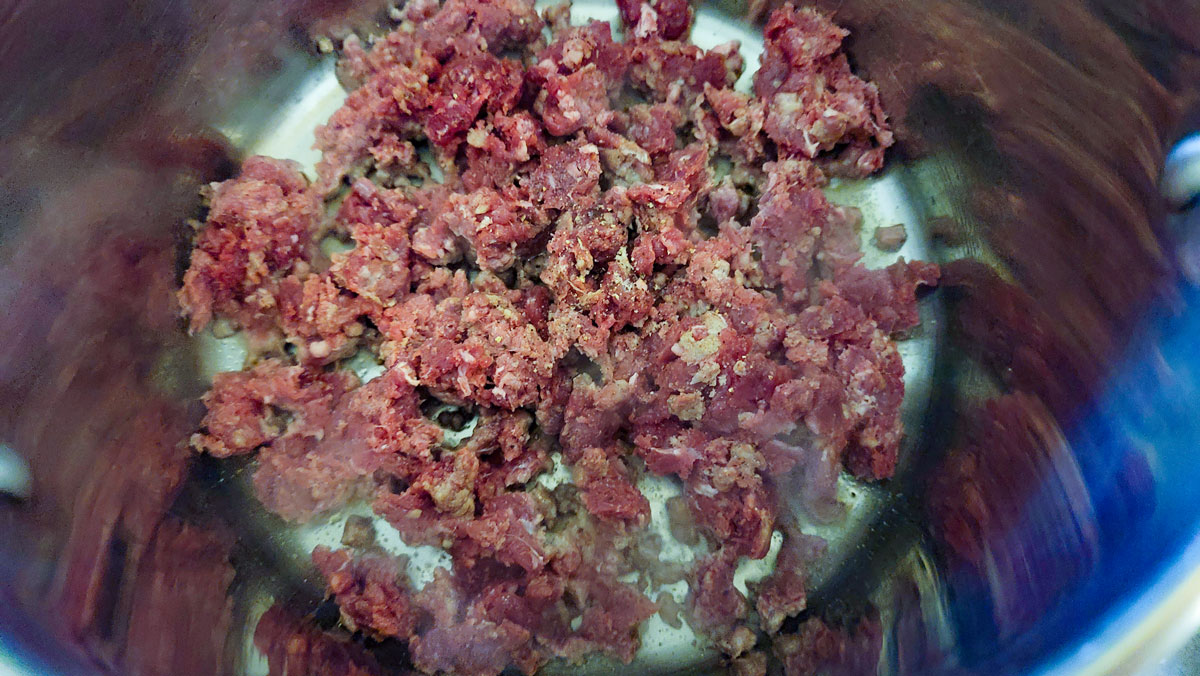 Browning the venison in a stainless pot.