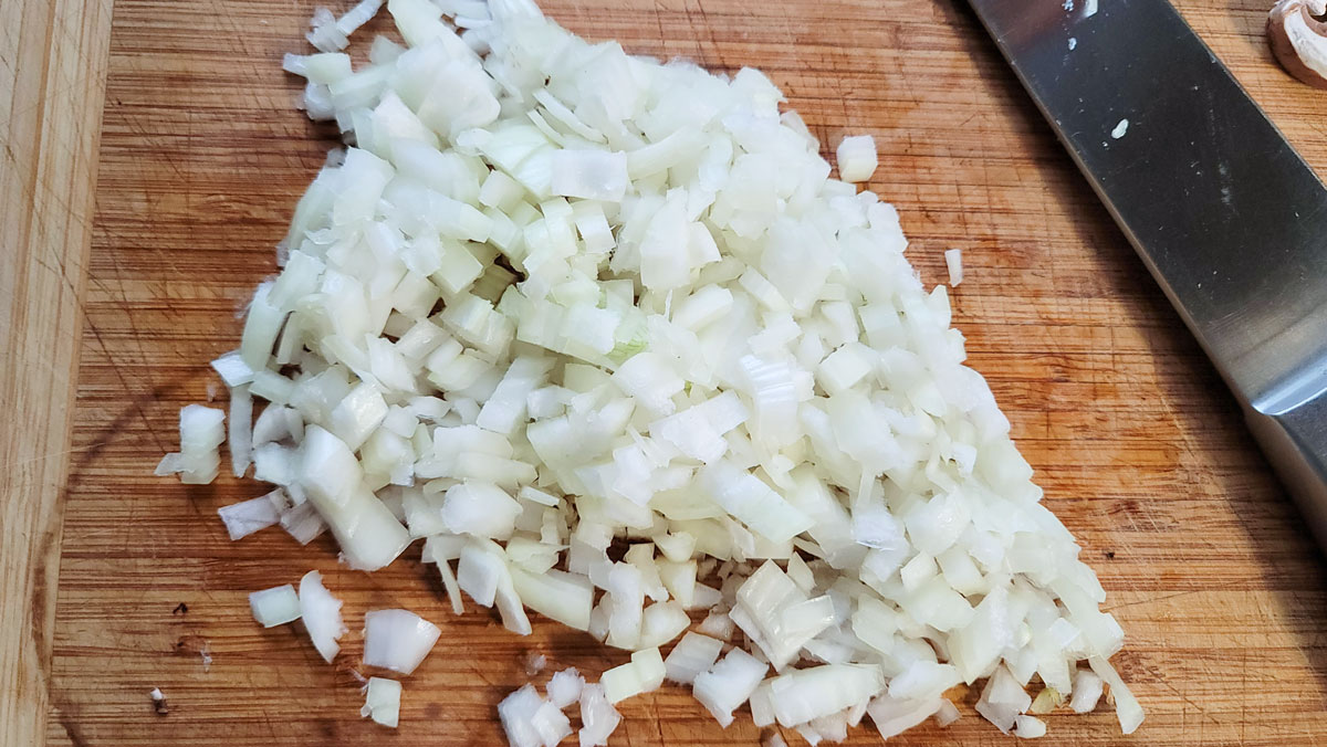 Diced onion on a board.