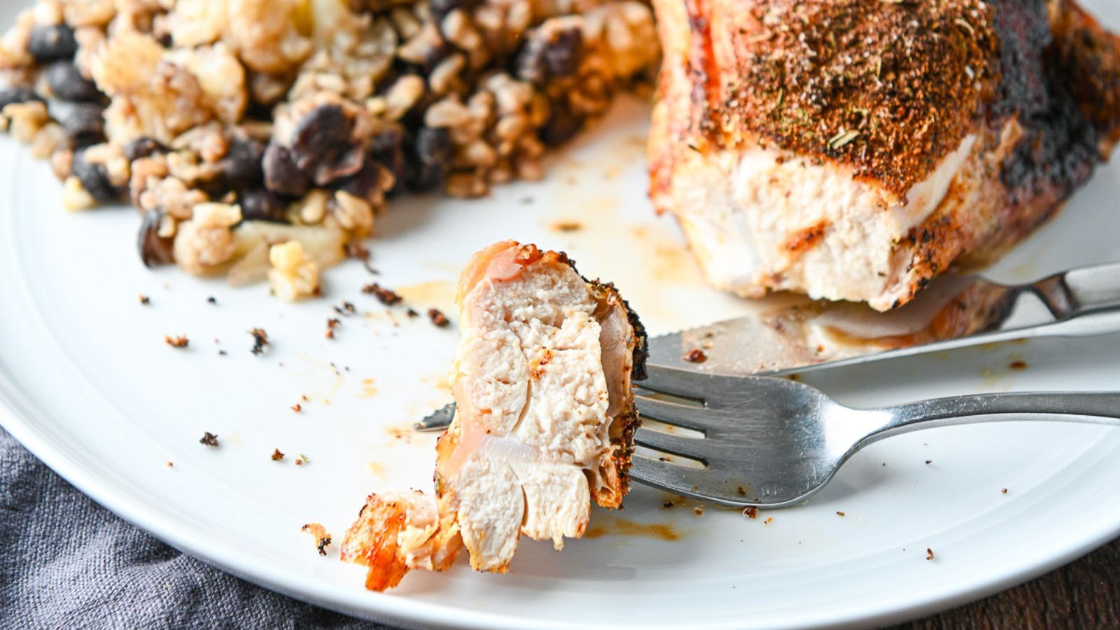 Juicy slice of chicken breast on a fork.