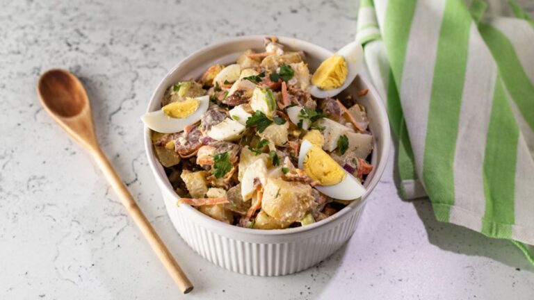 Bacon, potato and egg salad in a bowl.