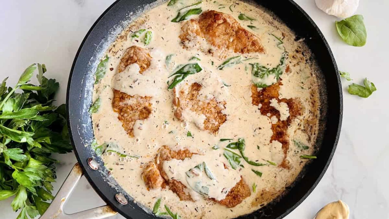 Creamy dihon pork chops in a pot.