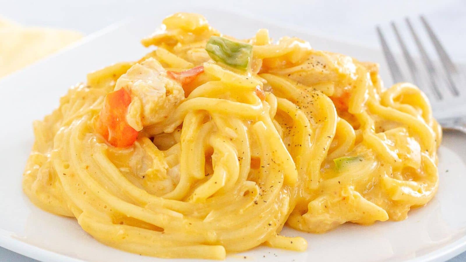 Twirled spaghetti on a white plate.