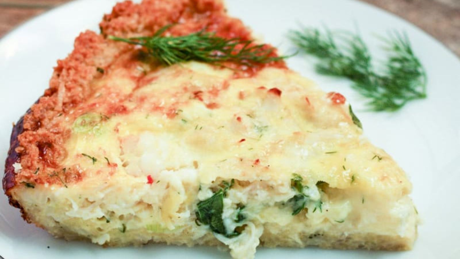 slice of crab and shrimp quiche on white plate