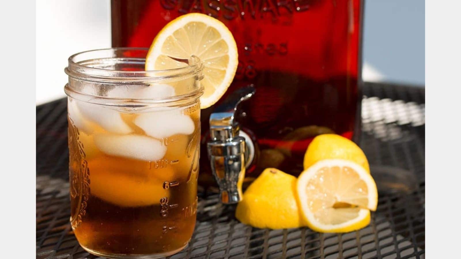 Glass of tea garnished with lemon slices.