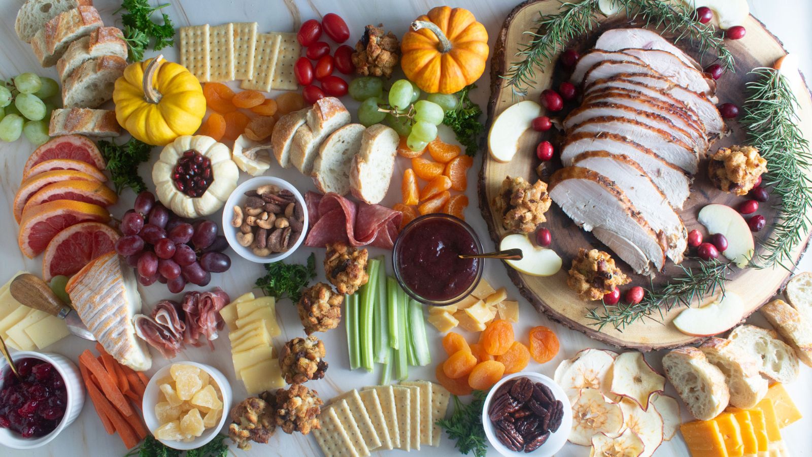 Epic Fall Charcuterie Board with cheeses, turkey, bread, cranberries.
