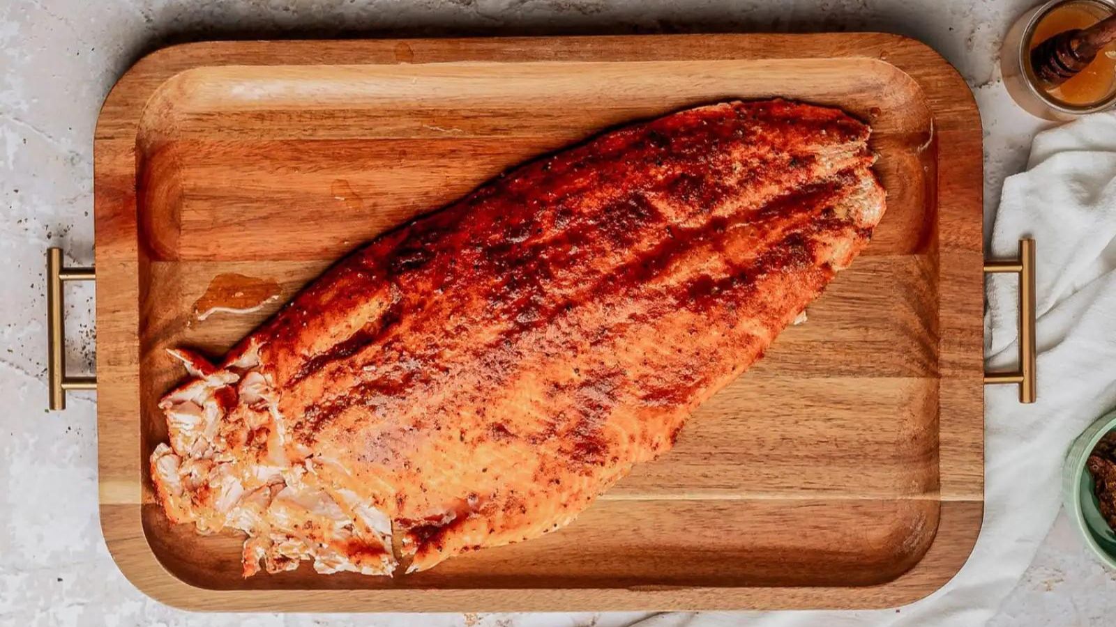 Salmon filet on a large wooden board.