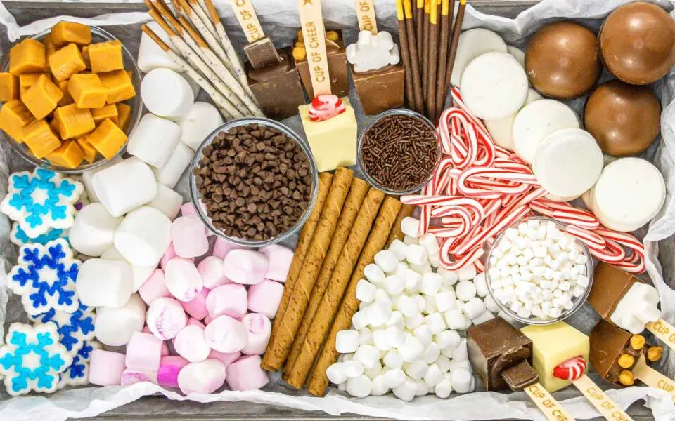 Hot chocolate charcuterie board with chocolates, marshmallows and peppermint.