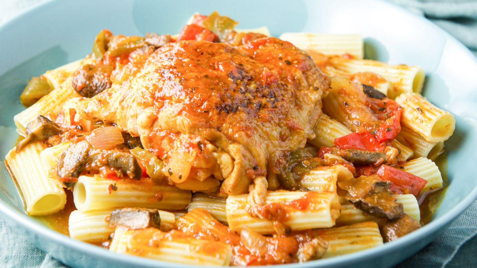 Chicken breast atop pile of pasta
