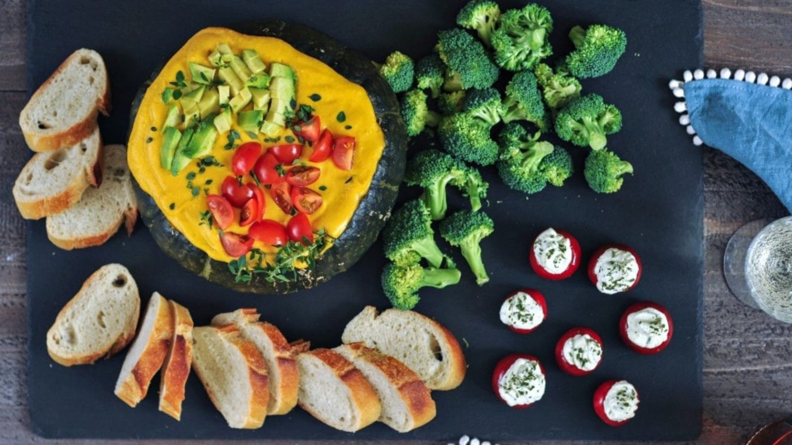 Kobocha squash filled with dip with toasted baguette and vege
tables for dipping.
