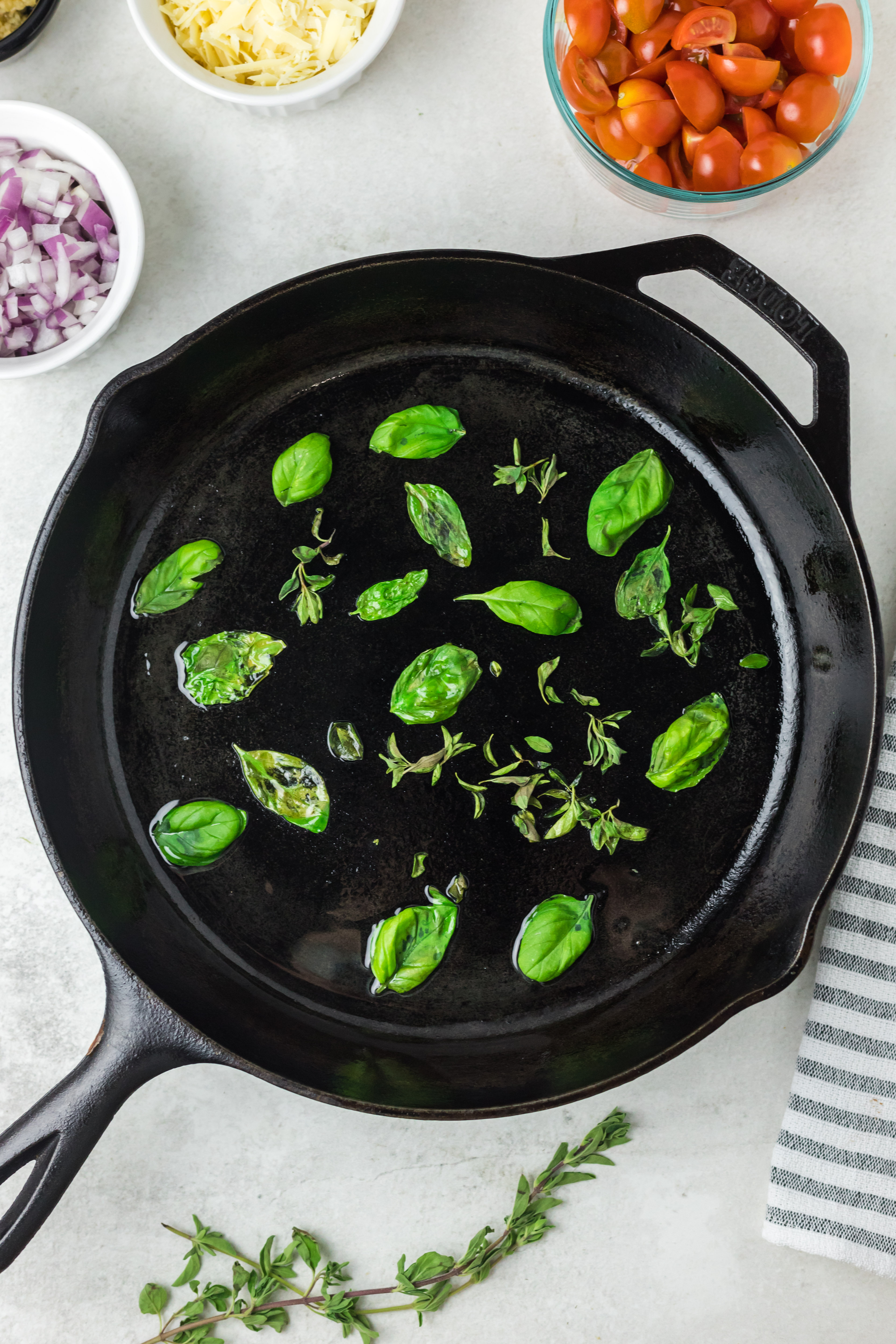 Basil leaves in a cast iron skillet.