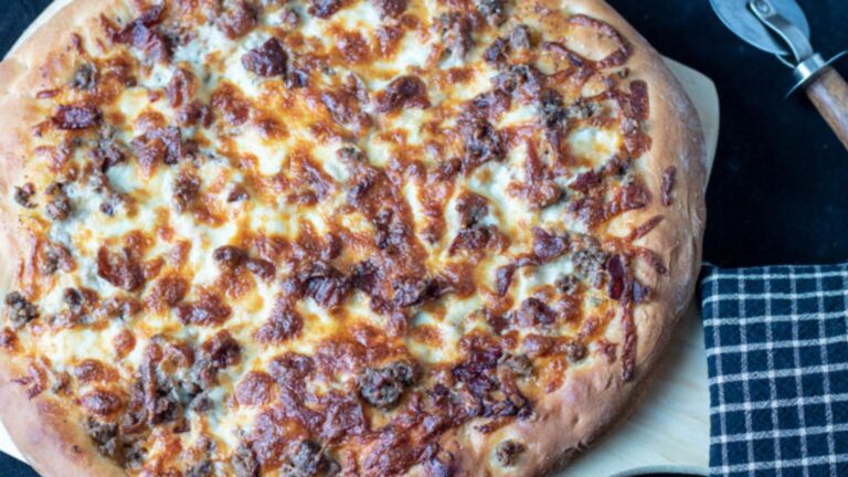 Whole pizza on a pizza peel.