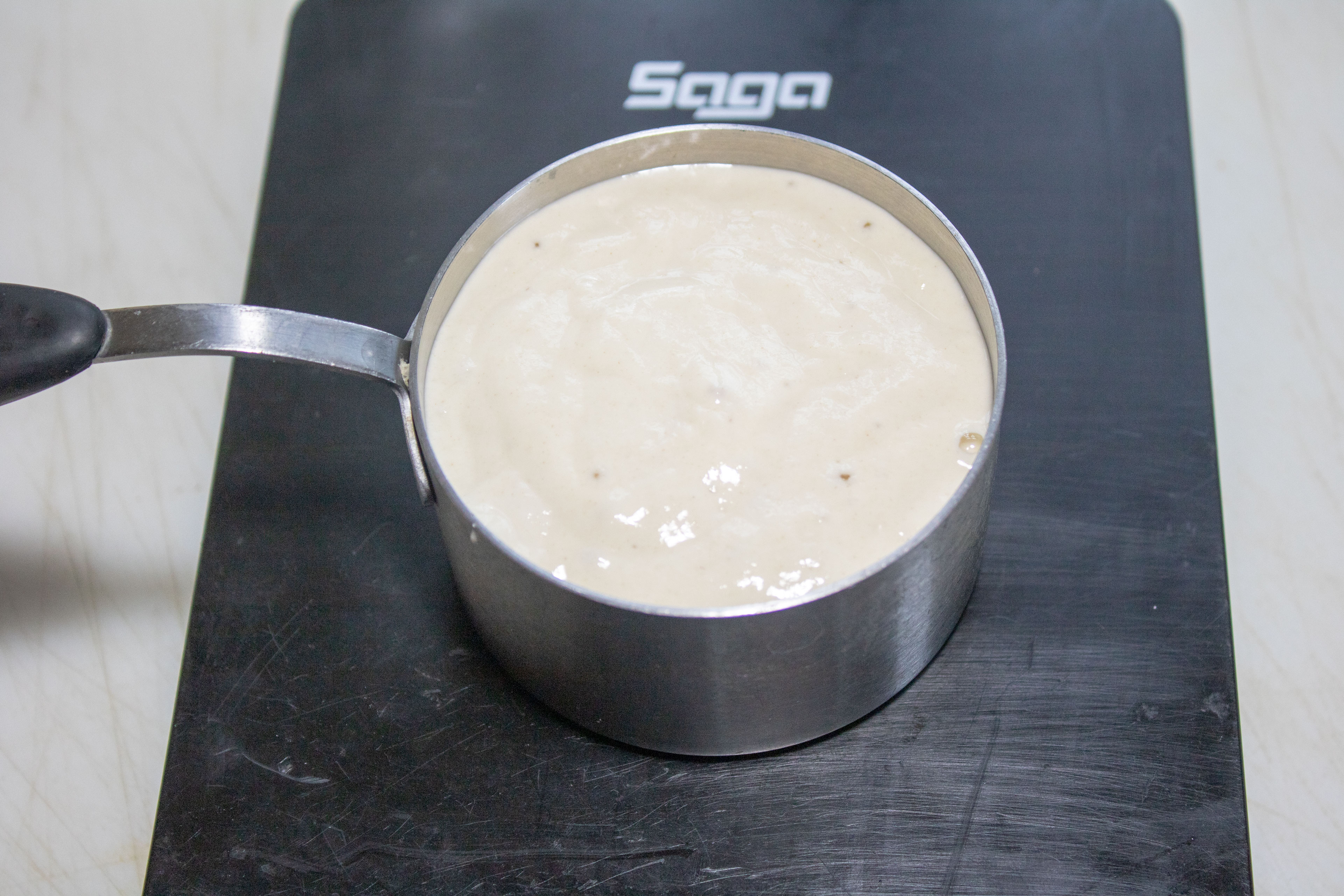 Sourdough discard in a measuring cup.