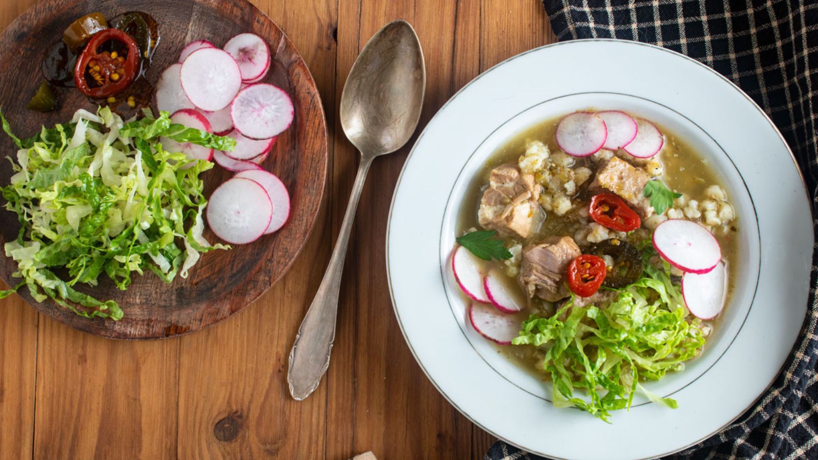 White bowl of soup on a wooden background.