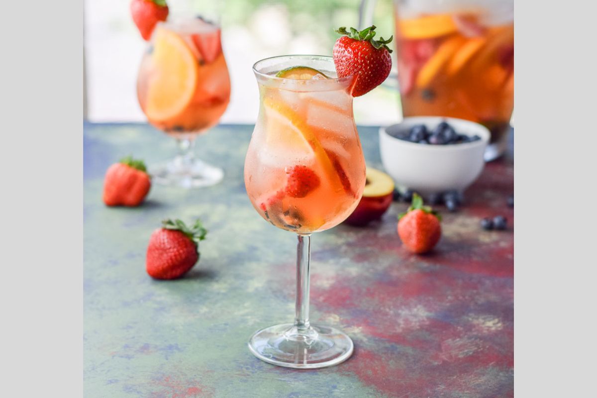White sangria with strawberry garnish.
