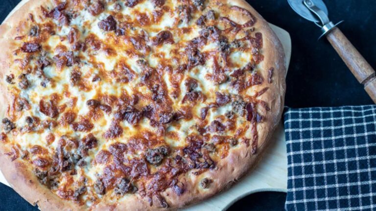 Whole pizza on pizza peel.