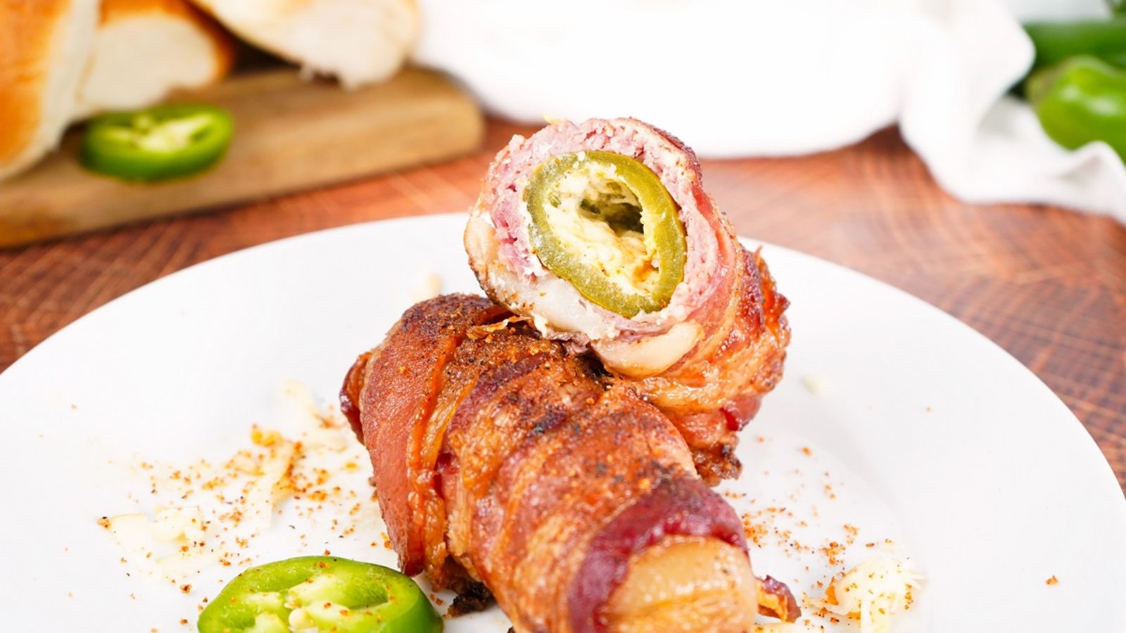Bacon wrapped armadillo on a plate.