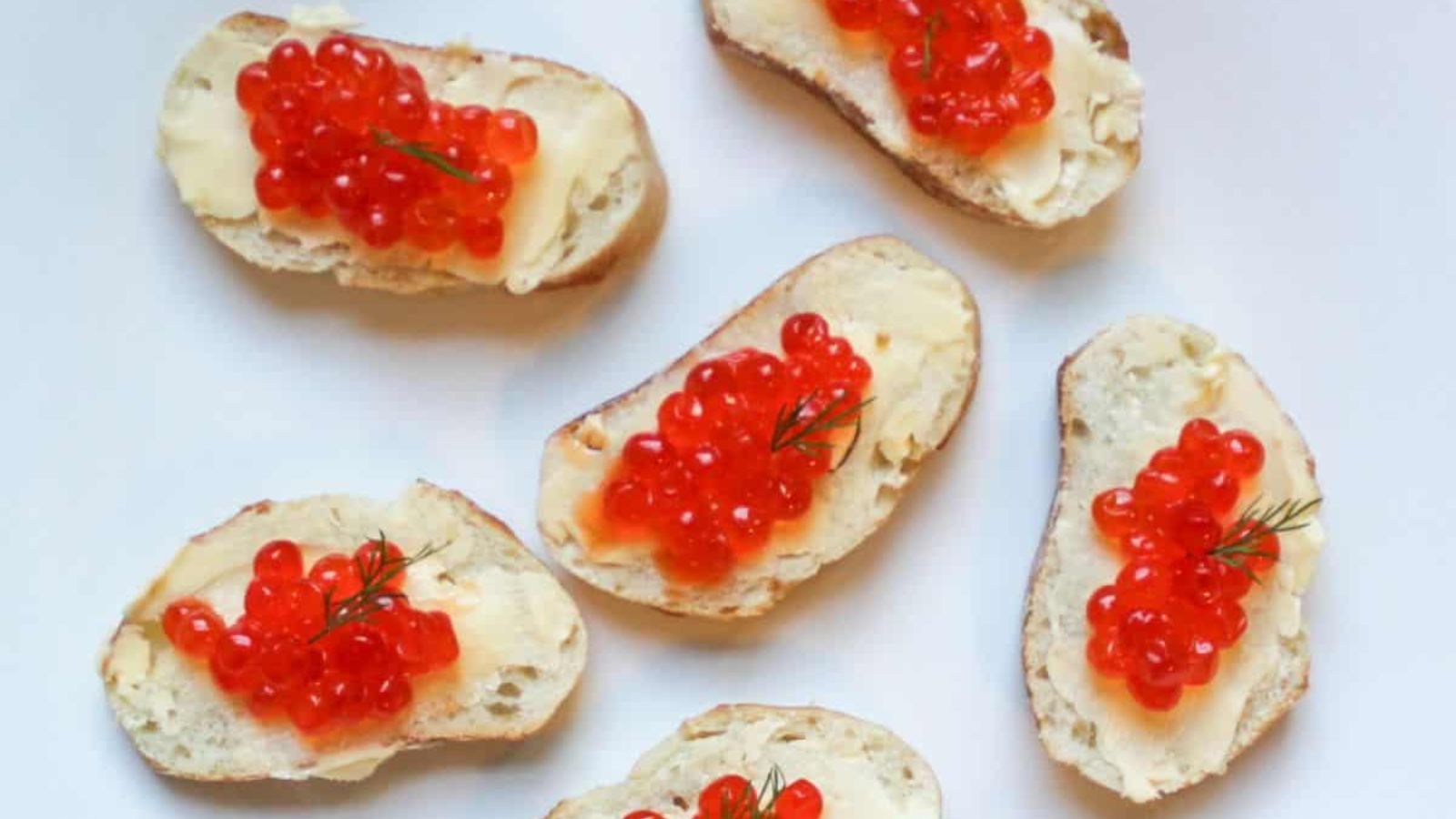 Caviar canapes on a white background.
