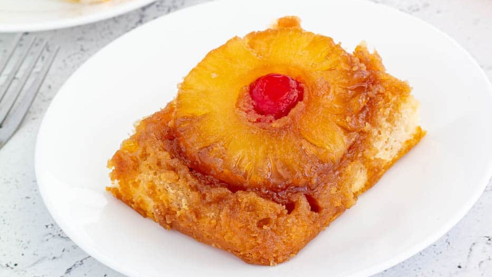 Pineapple upside down cake on a plate.