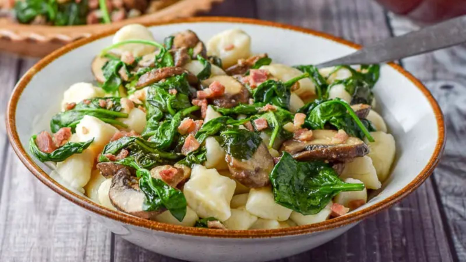 Gnocchi with pancetta in a bowl.