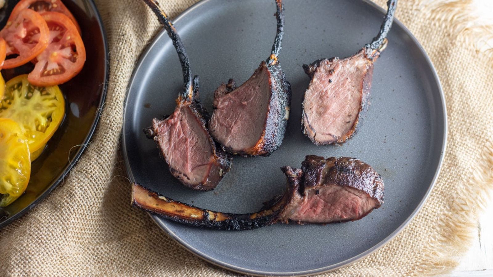 Venison loin chops on gray plate.