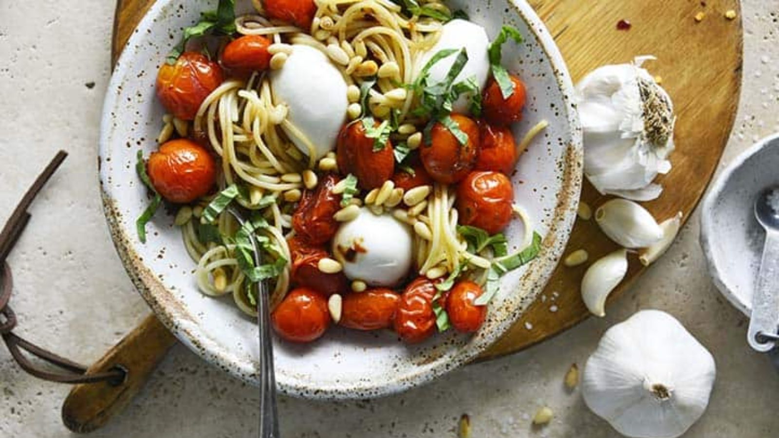 Pasta with roasted tomatoes on a plate.