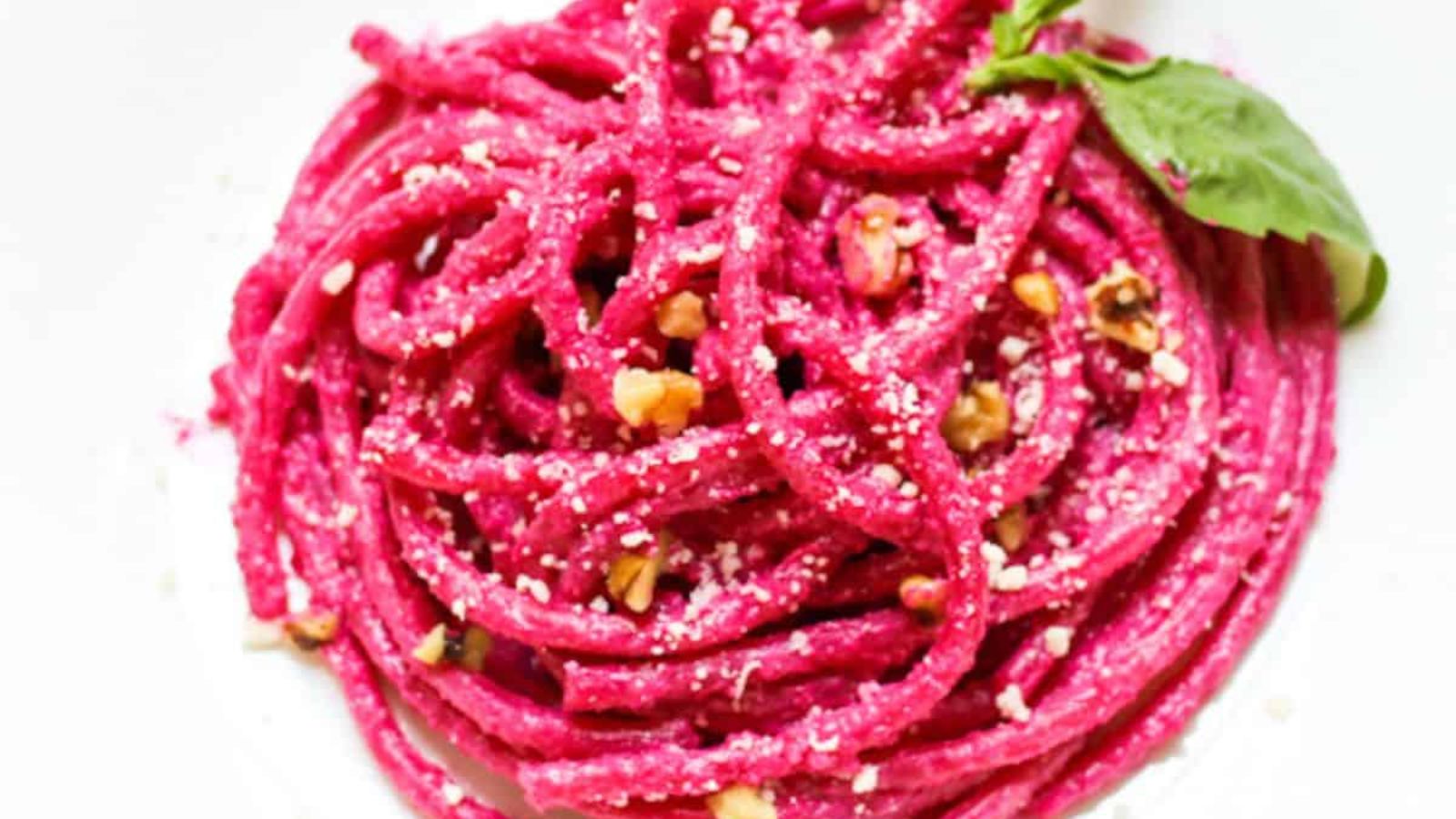 Pasta with beet sauce on a plate.
