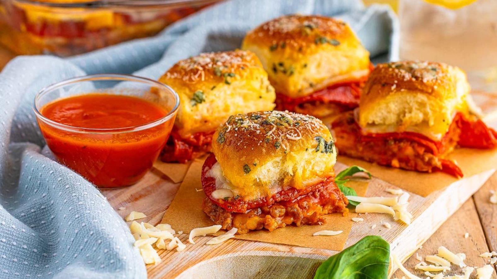 Four pizza sliders on a board.