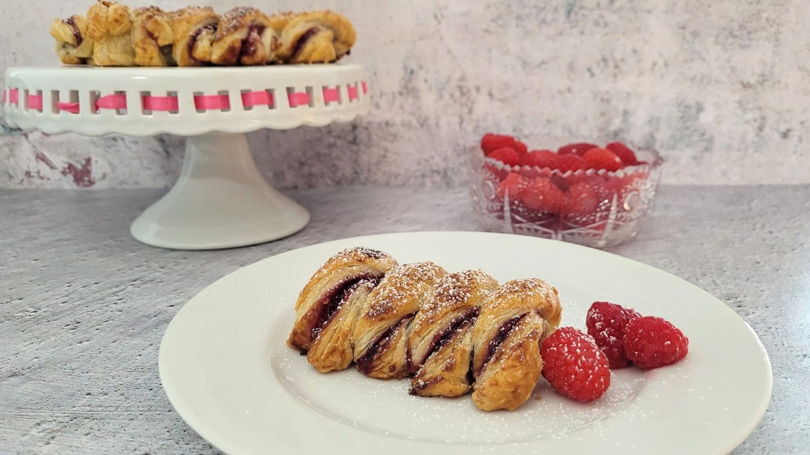 Raspberry almond puff twist on a plate.