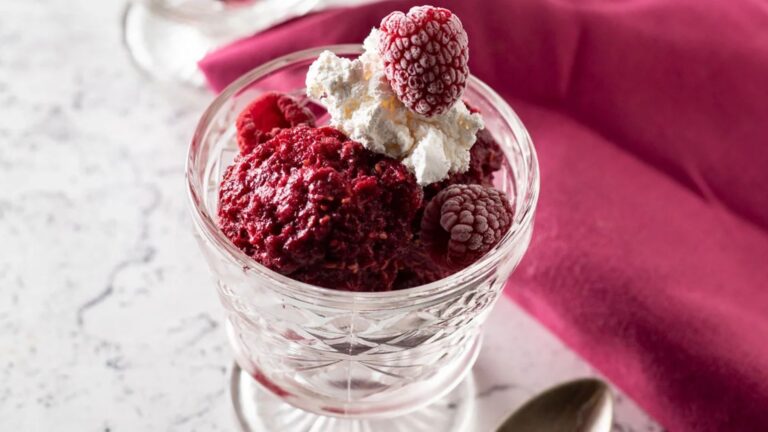 Pink raspberry sorbet in dessert fluted dishes.