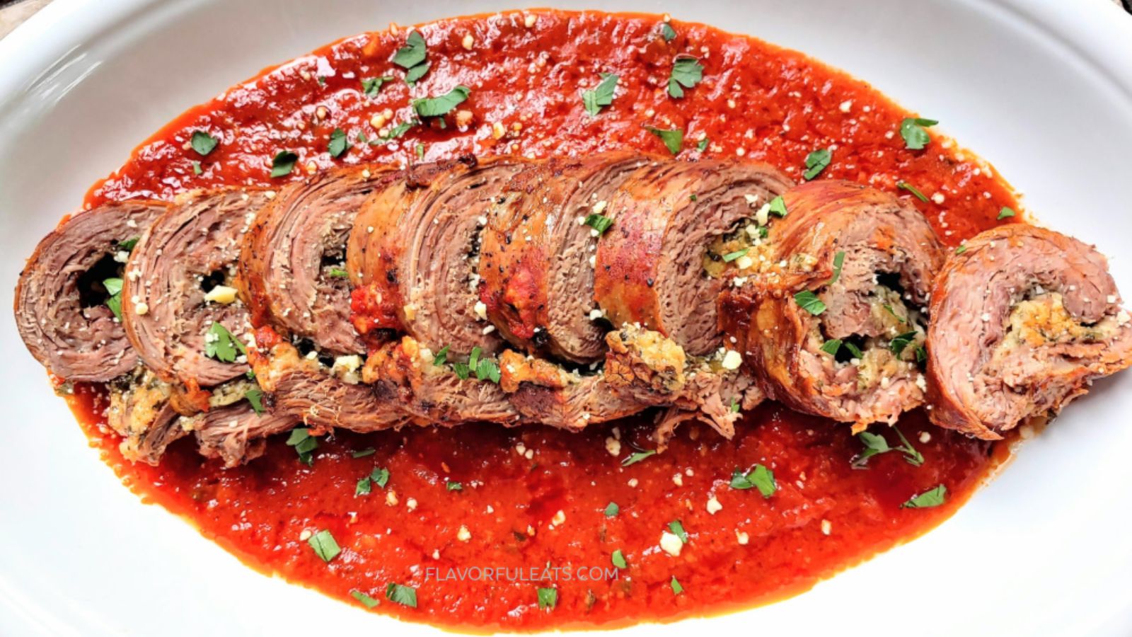 Beef braciole slices on a plate.