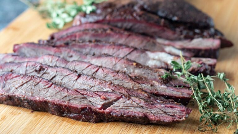 Venison brisket slices on a wooden board.