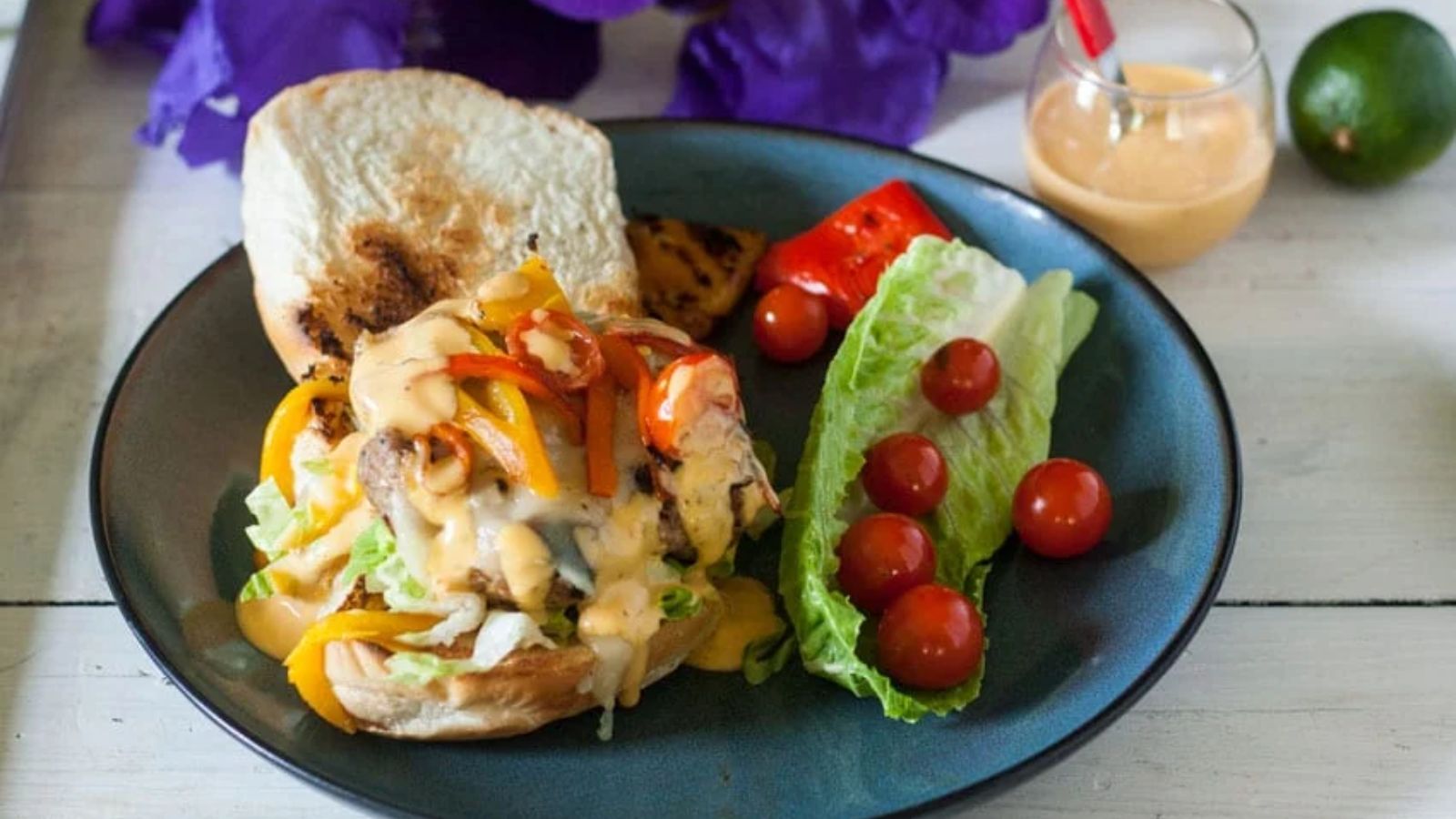 Turkey burger on buns covered with chipotle sauce.