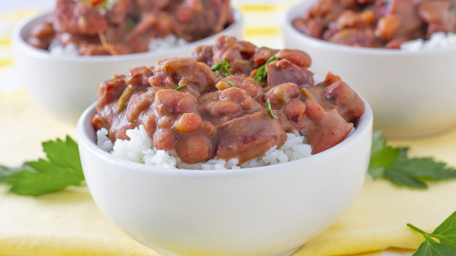 Red beans and rice in three white bowls.