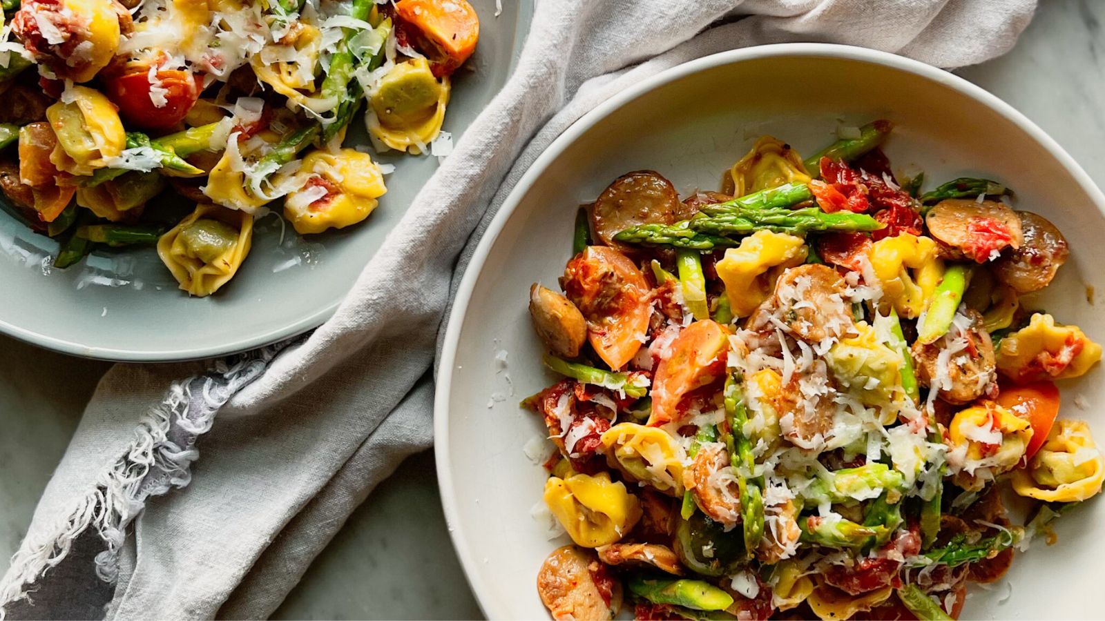 Tortellini with chicken and sausage on a plate.