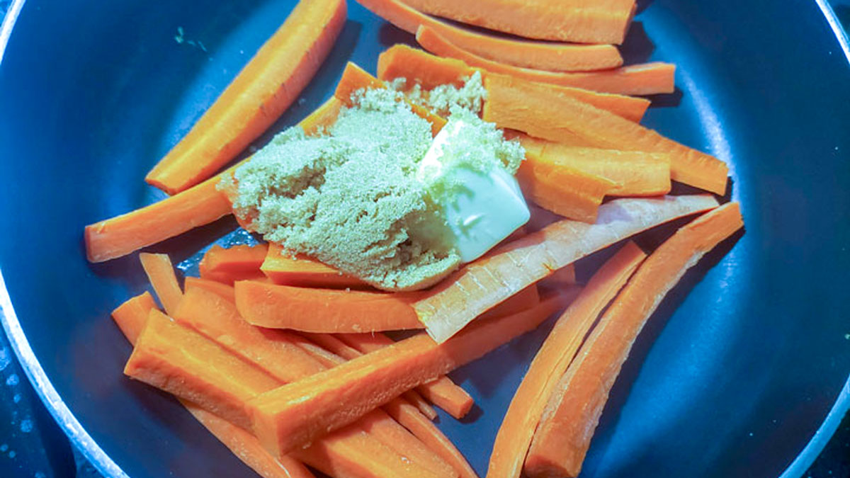Brown sugar added to the carrots in the skillet.