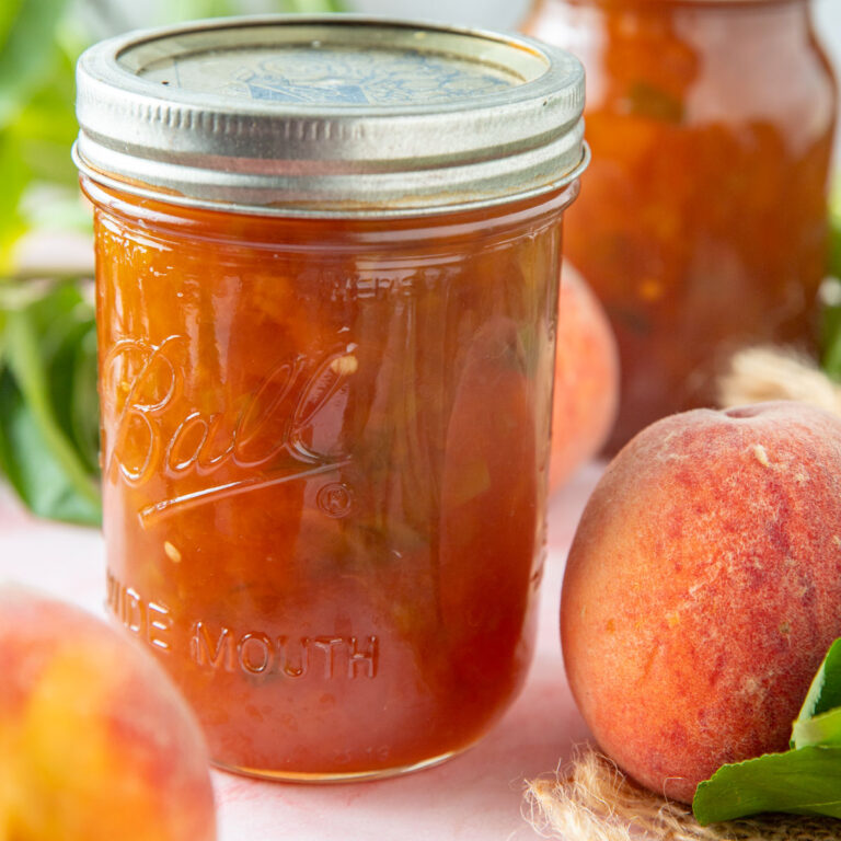 Close up of peach jam in a pint jar.