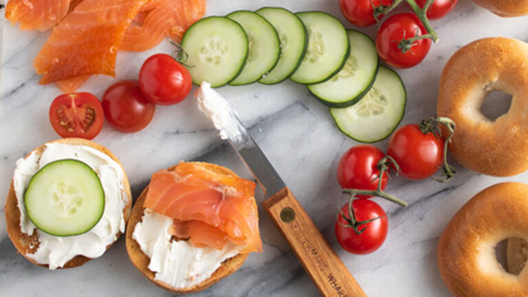 Smoked salmon on a mini bagel with cherry tomatoes and cucumbers.